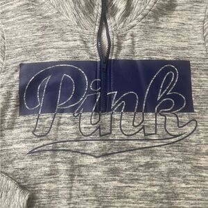 Pink quarter zip pullover, grey and blue in color